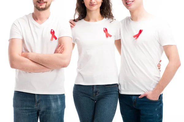 Cropped image of men and woman with red ribbons hugging isolated on white, world aids day concept — Stock Photo