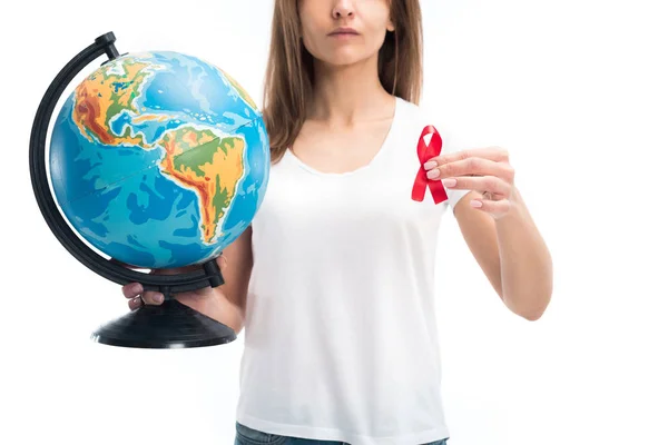 Cropped image of woman holding globe and red ribbon isolated on white, world aids day concept — Stock Photo