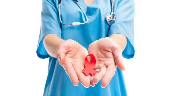 Cropped image of doctor holding red ribbon in hands isolated on white, world aids day concept — Stock Photo