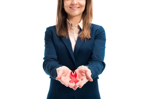 Cropped image of businesswoman holding red ribbon in hands isolated on white, world aids day concept — Stock Photo