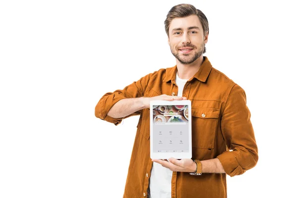 Homme heureux montrant tablette numérique avec quatre carrés sur l'écran isolé sur blanc — Photo de stock