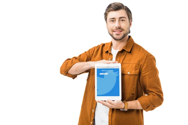 Positive young man showing digital tablet with twitter on screen isolated on white — Stock Photo