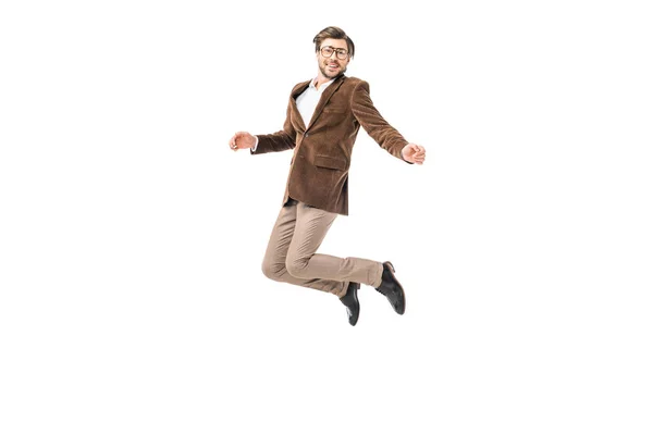 Felice modello maschile in occhiali e giacca di velluto saltando isolato su bianco — Foto stock