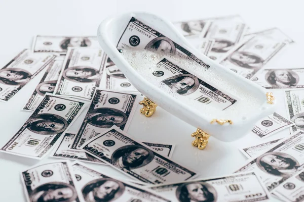 Close-up view of dollar banknotes and small bathtub, money laundering concept — Stock Photo