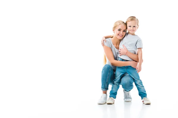 Mother and her son hugging each other and looking at camera isolated on white — Stock Photo