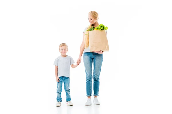 Madre e figlio dopo lo shopping con sacchetto di carta alimentare isolato su bianco — Foto stock