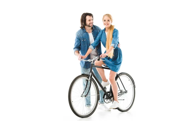 Блондинка їде на велосипеді і чоловік допомагає їй ізольовано на білому — стокове фото