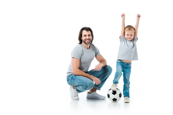 Pai feliz e filho animado jogando futebol isolado no branco — Fotografia de Stock