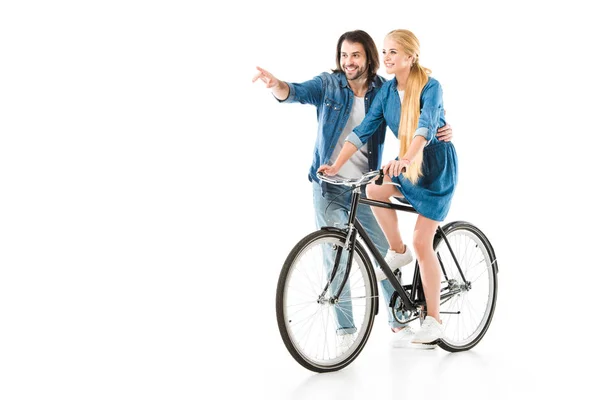 Happy couple having fun while woman riding bicycle isolated on white — Stock Photo