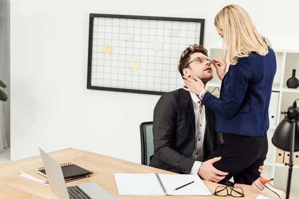 Attractive young businesswoman flirting with business colleague at workplace in office — Stock Photo