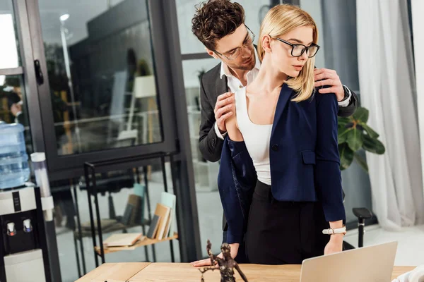 Businessman undressing businesswoman at workplace in office — Stock Photo