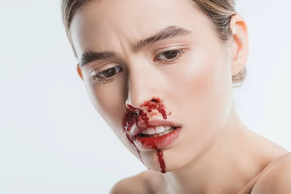 Close up of sad wounded woman with blood in face after domestic violence isolated on white — Stock Photo