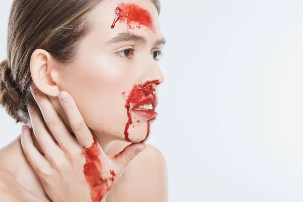 Close up of nude female domestic violence victim with red blood isolated on white — Stock Photo