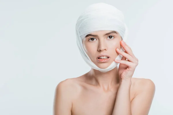 Nude woman with bandages on head after plastic surgery isolated on white — Stock Photo