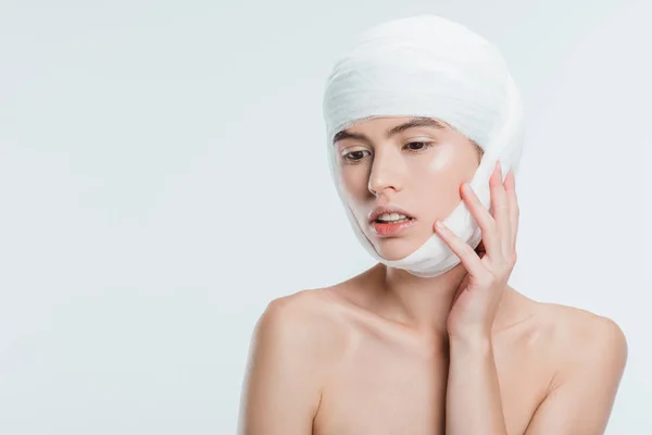 Nude woman with bandages on head after plastic surgery isolated on white — Stock Photo