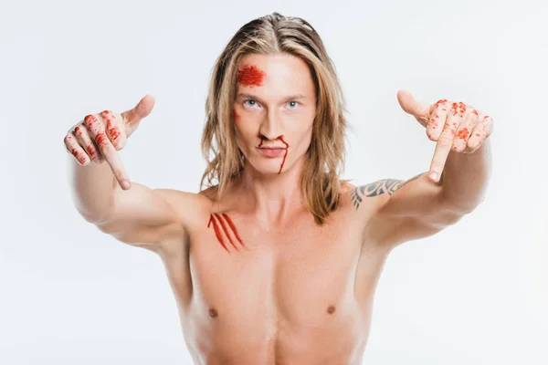 Nude handsome man with bloody wounds showing middle fingers isolated on white — Stock Photo