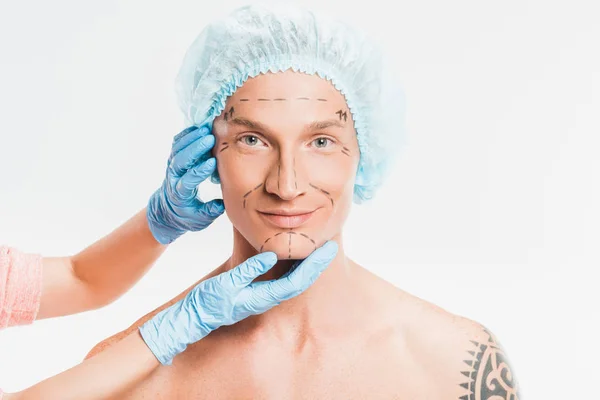 Close up of adult man with marks on face preparing for plastic surgery isolated on white — Stock Photo