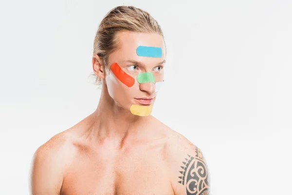 Naked handsome man with multicolored patches on face isolated on white — Stock Photo