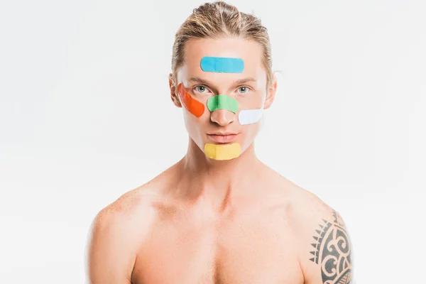 Naked handsome man with multicolored patches on face isolated on white — Stock Photo