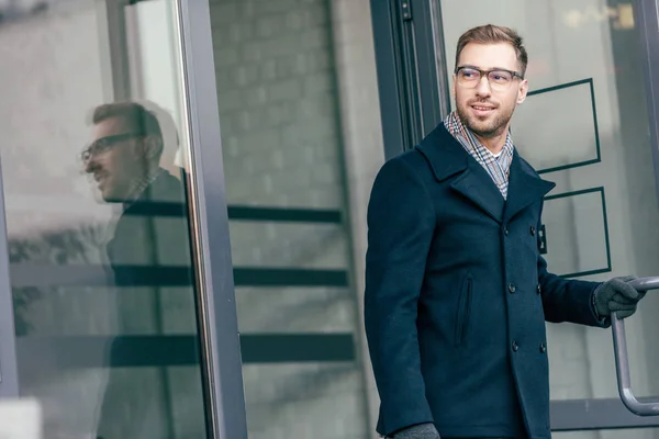 Adult handsome man in glasses leaving building — Stock Photo