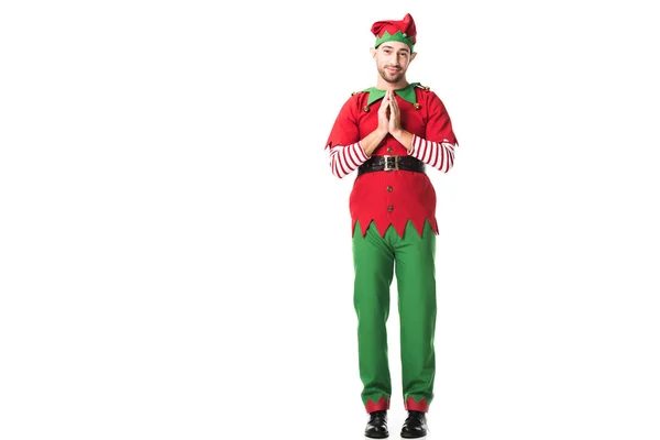 Человек в рождественском костюме эльфа держит ладони вместе, как жест пожалуйста и с обнадеживающим выражением изолированы на белом — стоковое фото