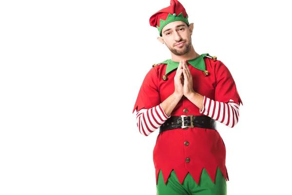 Homem em traje de elfo natal segurando palmas juntas como por favor gesto e tendo expressão esperançosa isolado no branco — Fotografia de Stock