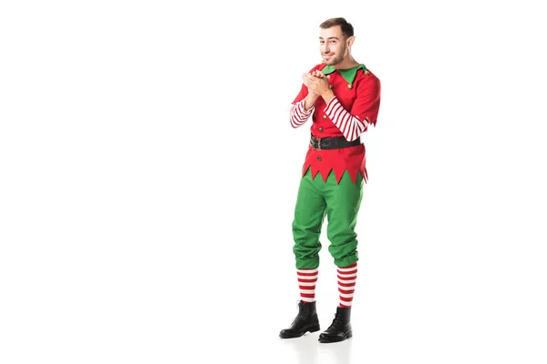 Excited smiling man in christmas elf costume looking at camera and rubbing hands in anticipation isolated on white — Stock Photo