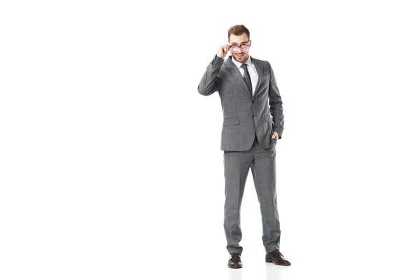 Bonito adulto empresário tocando óculos isolado no branco — Fotografia de Stock