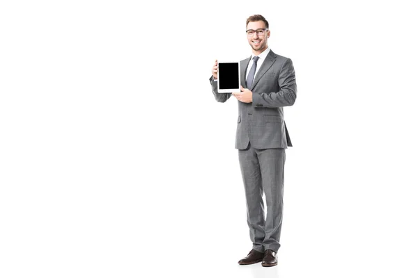 Взрослый улыбающийся бизнесмен держит цифровой планшет с чистым экраном изолирован на белом — стоковое фото