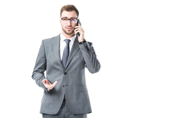 Adult businessman in glasses talking on smartphone isolated on white — Stock Photo