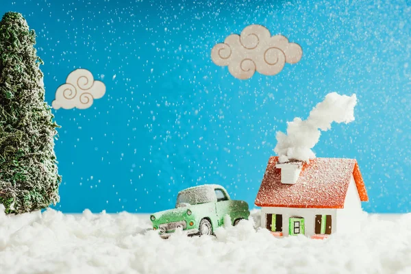 Close-up shot of toy car and house covered with snow, christmas concept — Stock Photo