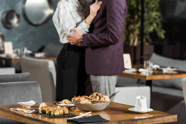 Cropped view of hugging dancing couple in restaurant — Stock Photo