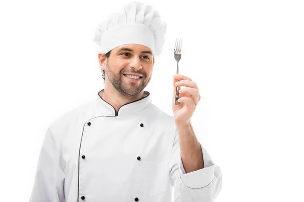 Souriant jeune chef tenant fourchette isolé sur blanc — Photo de stock