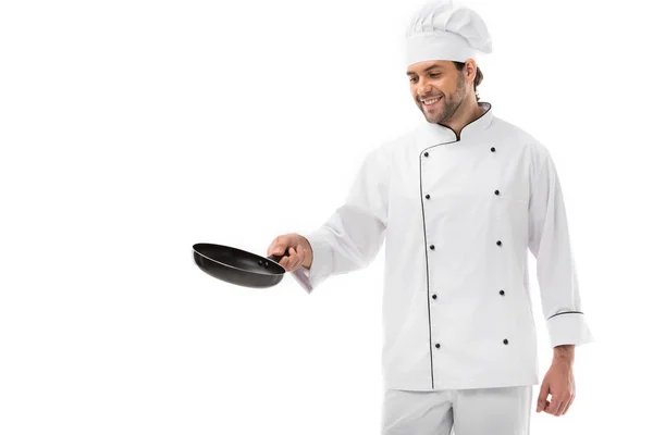 Happy young chef cooking with frying pan isolated on white — Stock Photo