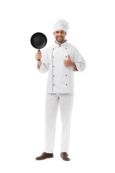 Feliz joven chef con sartén mostrando el pulgar hacia arriba aislado en blanco — Stock Photo