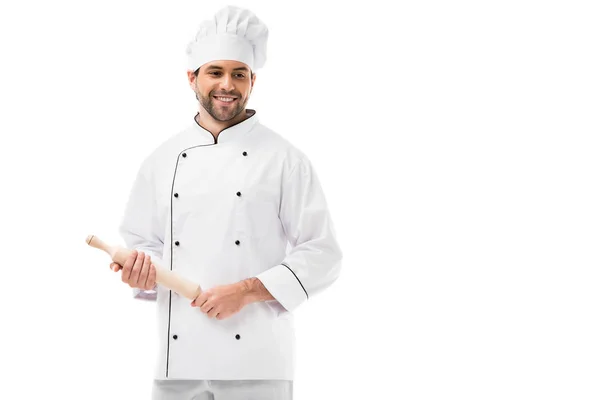 Smiling young chef holding rolling pin isolated on white — Stock Photo