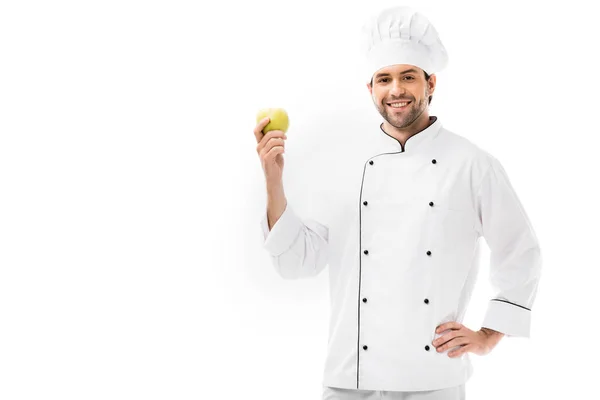 Handsome young chef holding apple and looking at camera isolated on white — Stock Photo