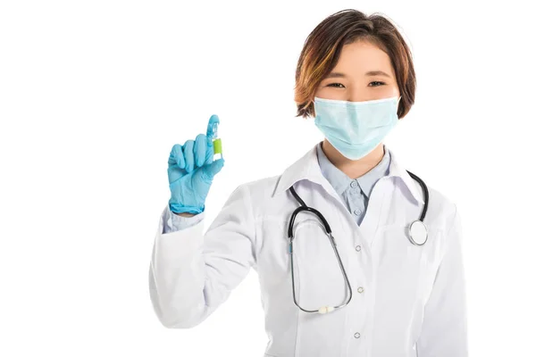 Smiling female doctor with stethoscope holding ampule and looking at camera isolated on white — Stock Photo