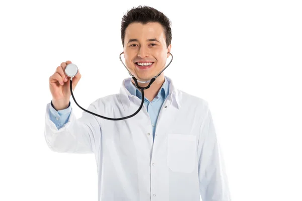 Sorridente médico masculino segurando estetoscópio e olhando para a câmera isolada no branco — Fotografia de Stock