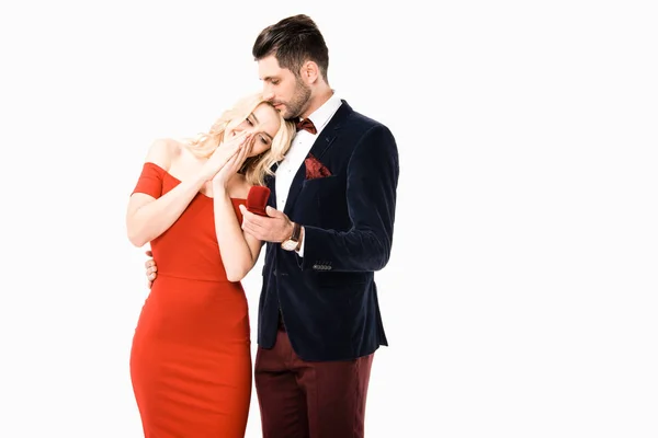 Happy couple hugging while man proposing girlfriend to marry isolated on white — Stock Photo