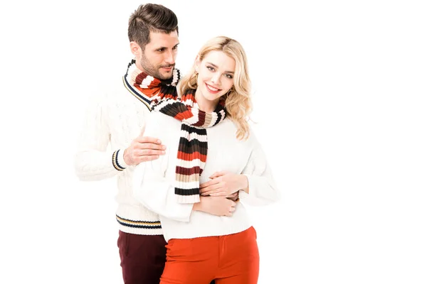 Romantic couple in knitted scrafs hugging isolated on white — Stock Photo