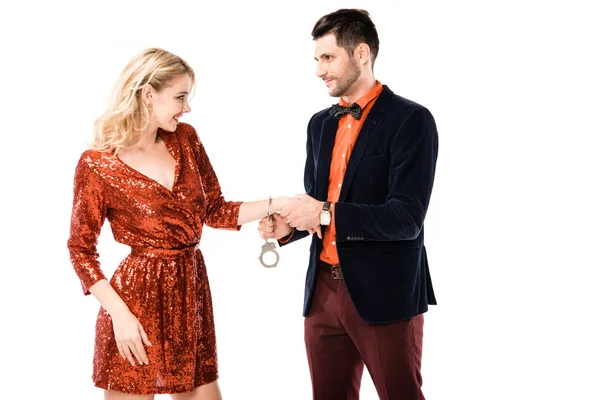 Handsome man in suit handcuffingbeautiful girlfriend isolated on white — Stock Photo