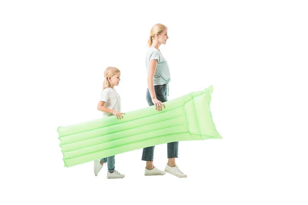 Mommy and daughter walking with air mattress isolated on white — Stock Photo