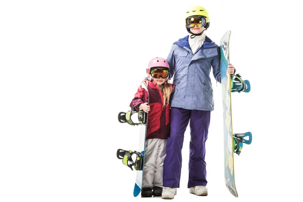 Adult mother and preschooler daughter in ski clothes with snowboards smiling isolated on white — Stock Photo