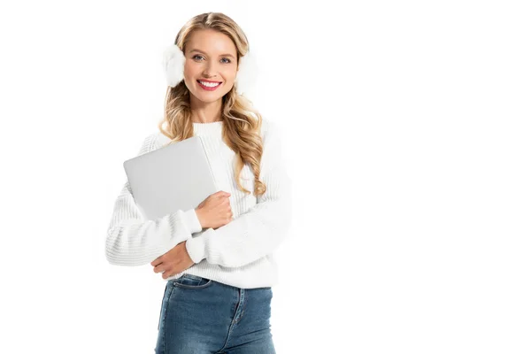 Attractive blonde smiling girl holding laptop isolated on white — Stock Photo