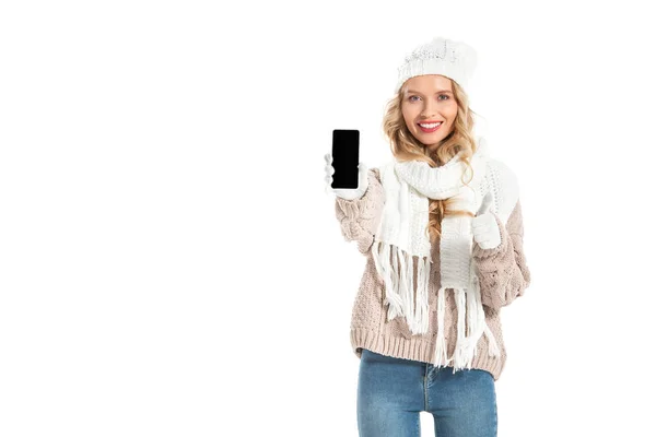 Menina bonita e mostrando o polegar para cima e smartphone com tela em branco isolado no branco — Fotografia de Stock