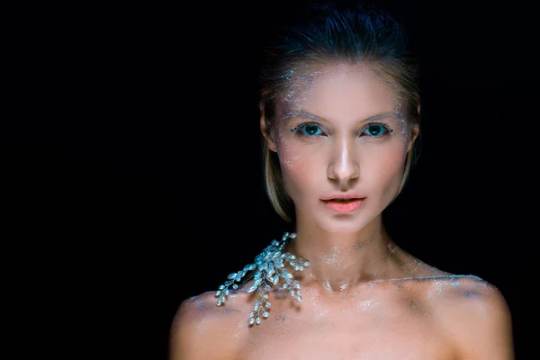 Attractive young woman with winter make up looking at camera isolated on black — Stock Photo