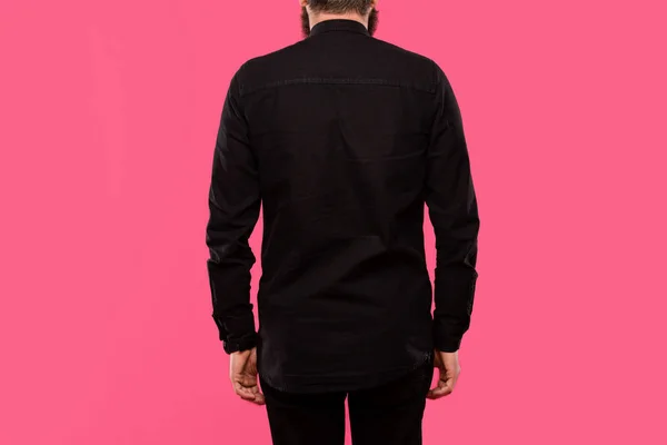 Rear view of man in black stylish shirt posing isolated on pink — Stock Photo