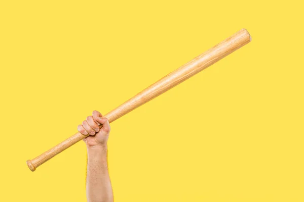 Cropped shot of person holding baseball bat isolated on yellow — Stock Photo
