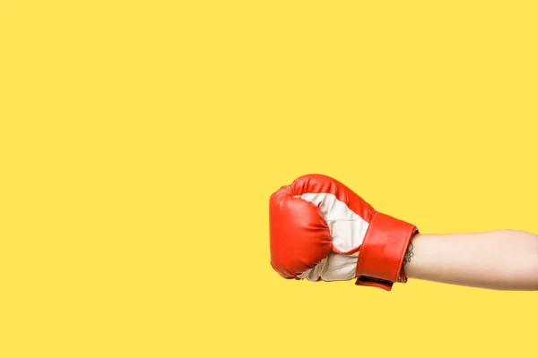 Cropped shot of girl wearing boxing glove isolated on yellow — Stock Photo